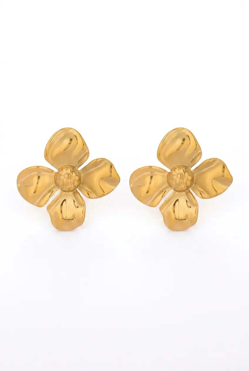 A pair of gold four-petal flower stud earrings on a plain white background.