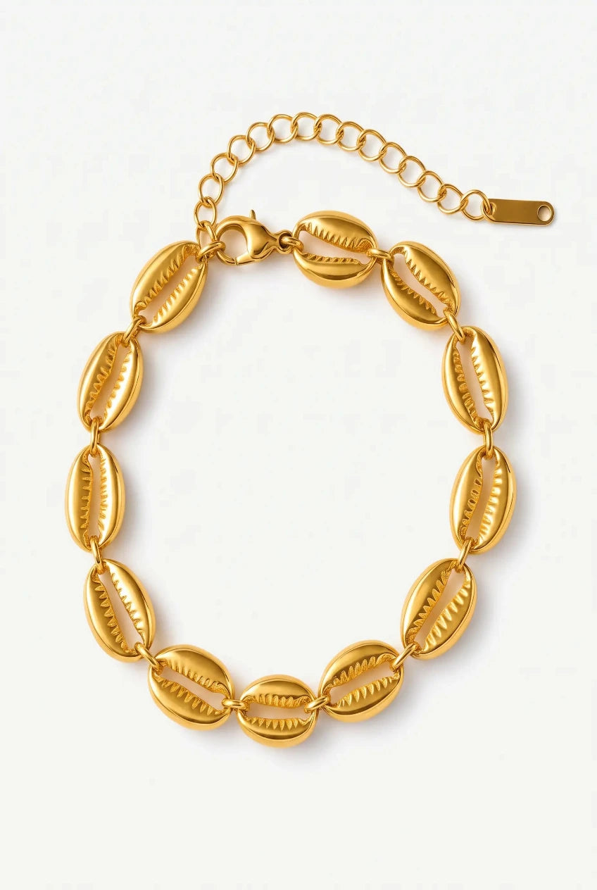 A gold-toned chain bracelet featuring nine elongated, textured shell-like links arranged in a circle, with an adjustable chain extender and clasp, shown on a plain light background.