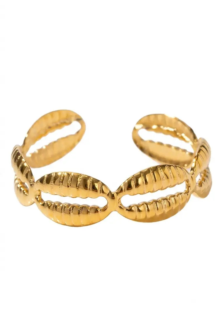 A gold-toned metal cuff bracelet featuring a series of textured, ribbed oval links resembling cowrie shells, shown against a plain white background.
