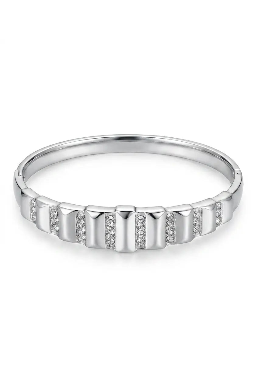 A silver-toned band ring featuring a series of vertical rectangular bars with small clear stones set along the front, shown on a plain white background.