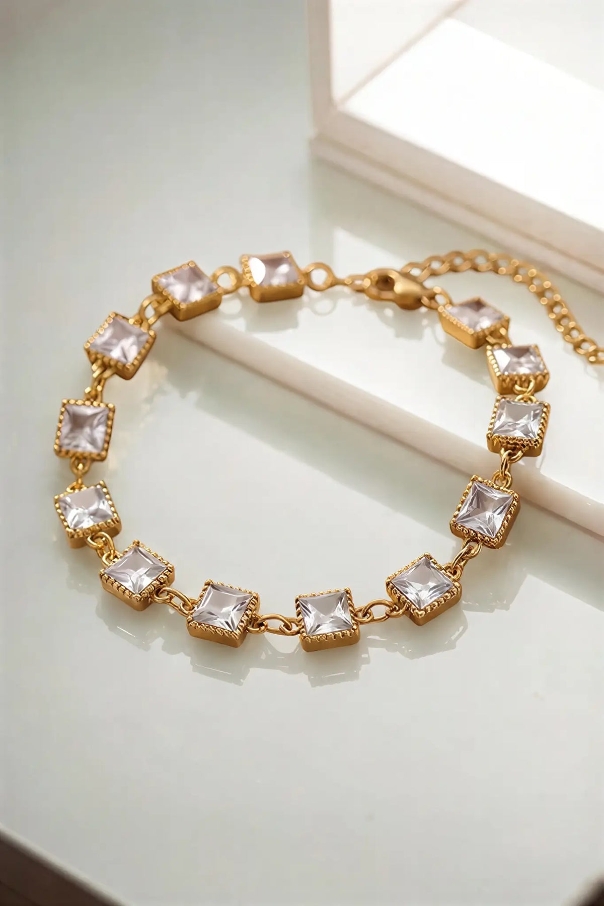 Princess cut crystal bracelet flat lay — YUBAMA 18K gold PVD crystal bracelet