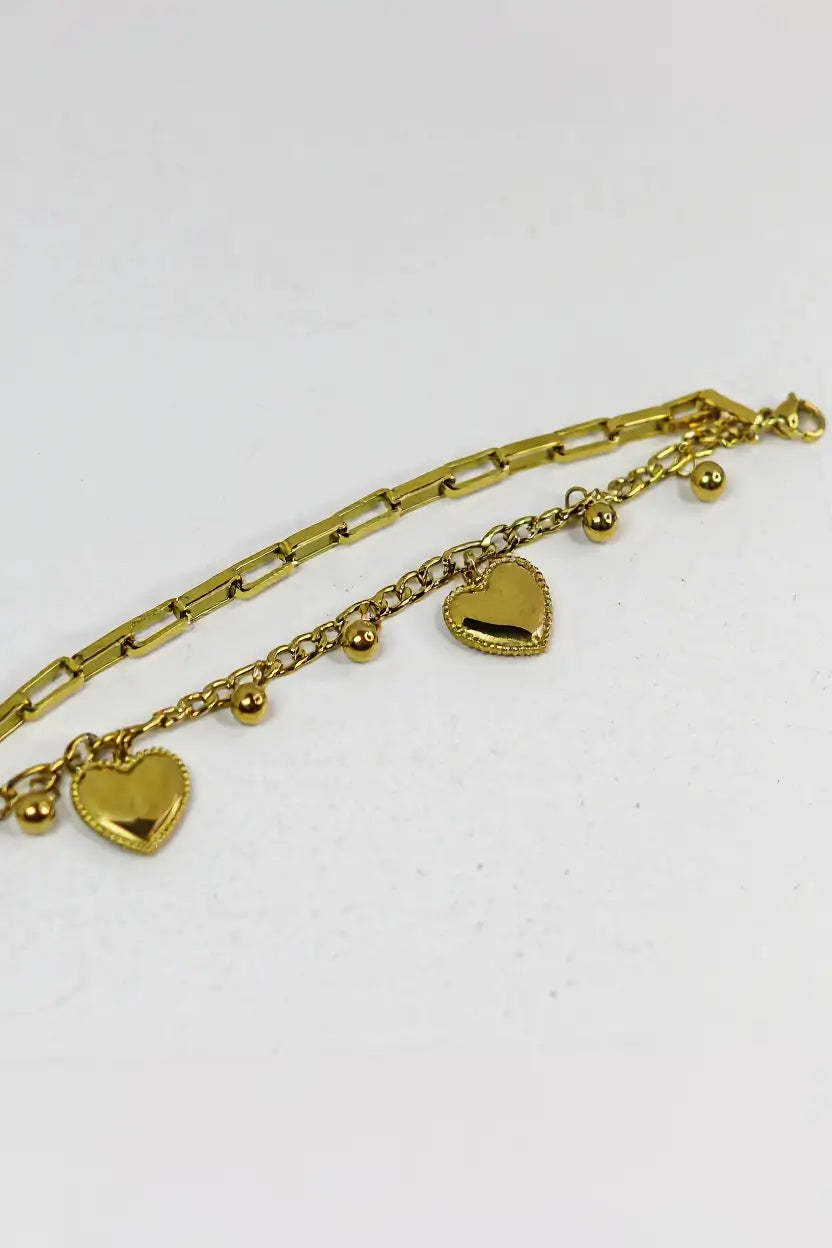 Layered heart charm bracelet flat lay — YUBAMA 18K gold PVD double chain bracelet