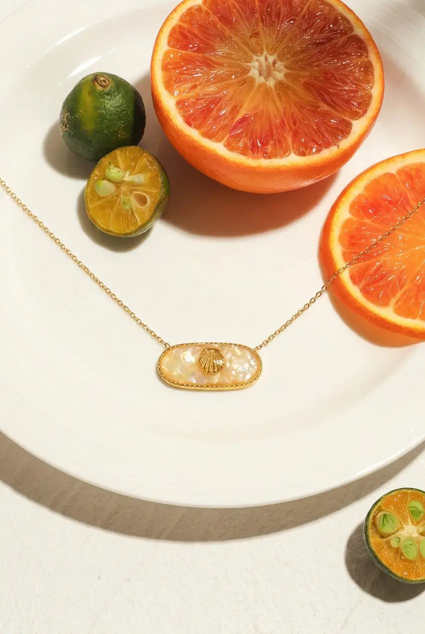Oval shell pendant necklace summer flat lay — YUBAMA waterproof gold shell necklace
