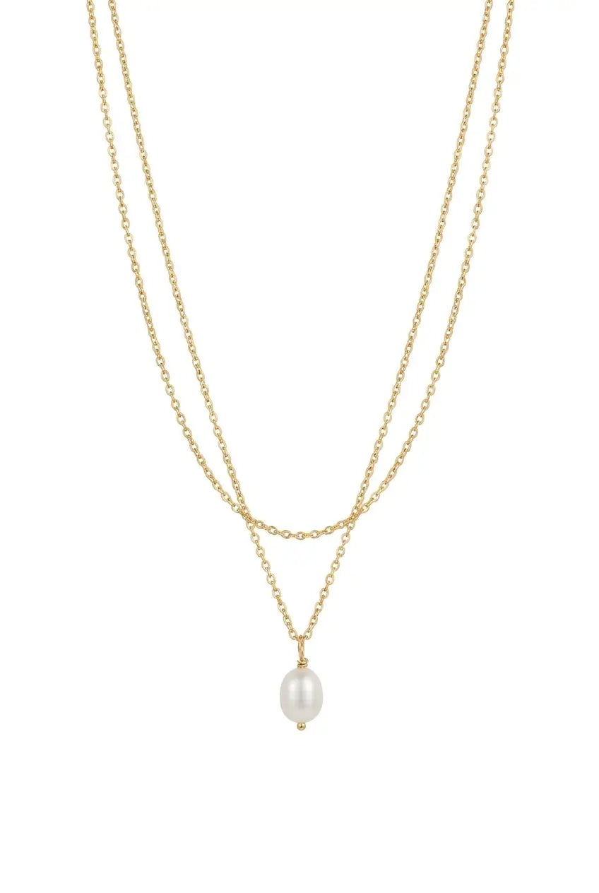 A delicate double-strand gold chain necklace featuring a small, oval white pearl pendant, displayed against a solid white background.