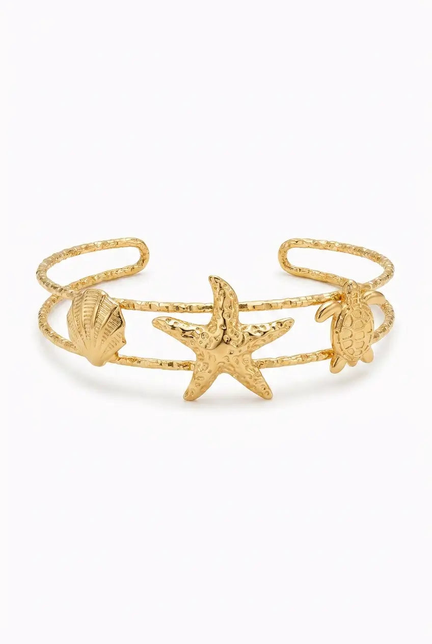 Gold bracelet with blue stones on a white background