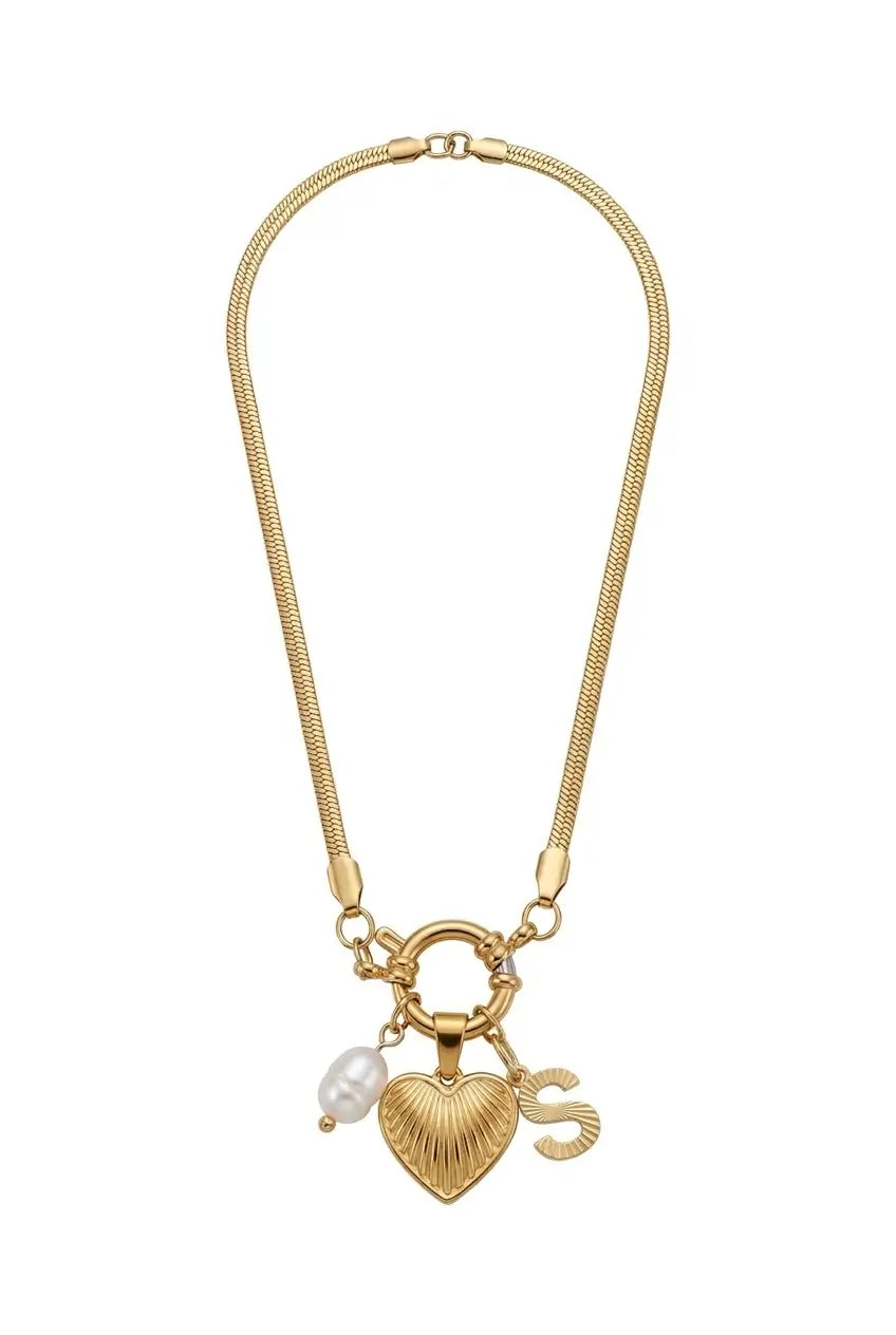 A gold-toned snake chain necklace featuring a heart-shaped charm with a textured finish, a small white pearl bead, and a stylized letter 'S' charm, displayed on a clean white background.