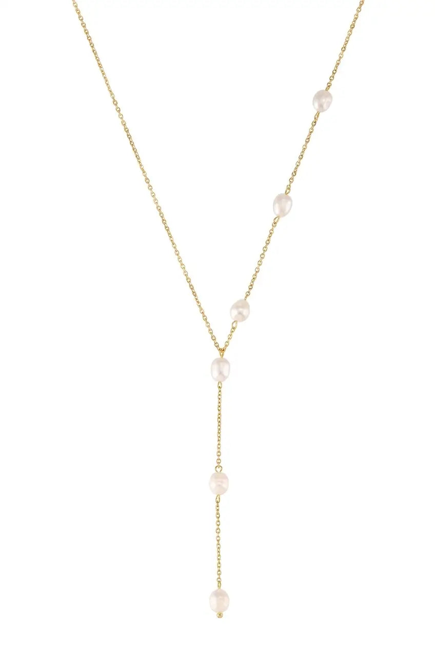 A delicate gold Y-necklace featuring five small, irregular white freshwater pearls spaced along the chain, presented on a solid white background.