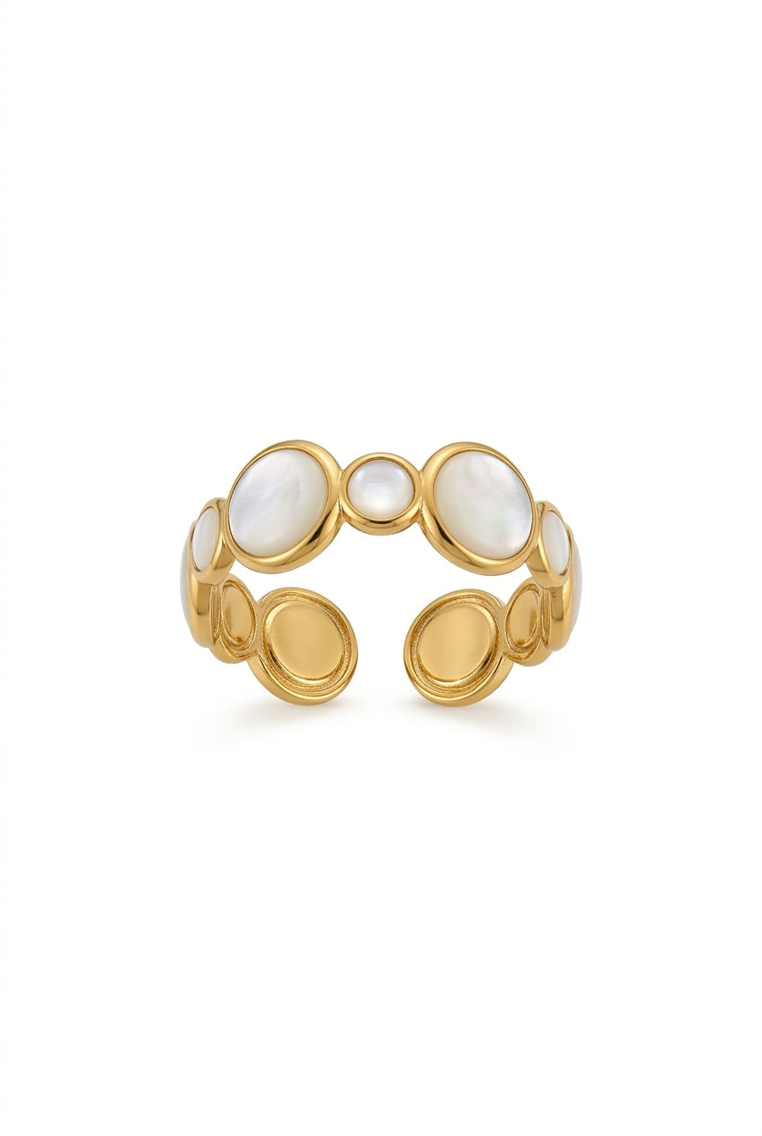 A gold-toned open cuff ring featuring multiple oval and circular inlaid white mother-of-pearl stones, displayed on a clean white background.