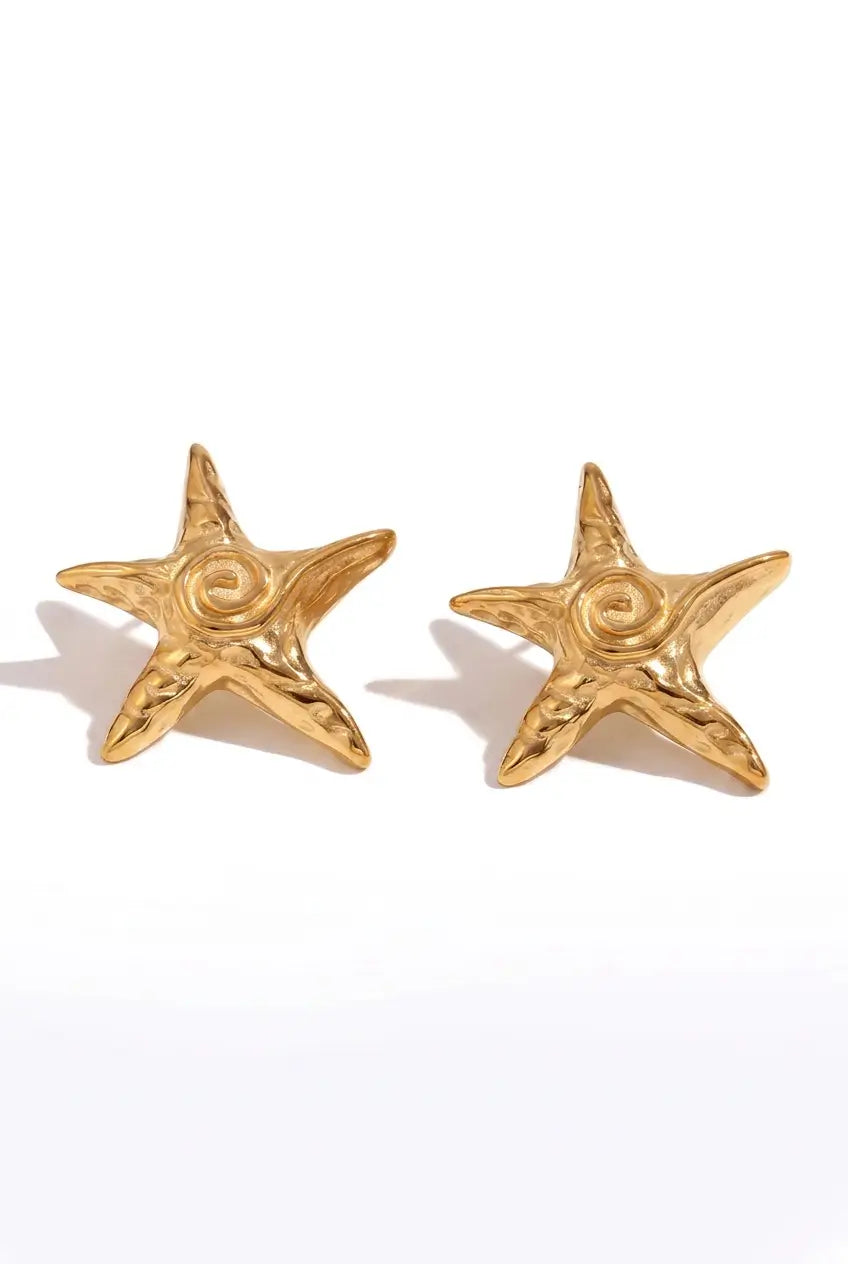 A pair of textured gold starfish stud earrings on a clean white background.