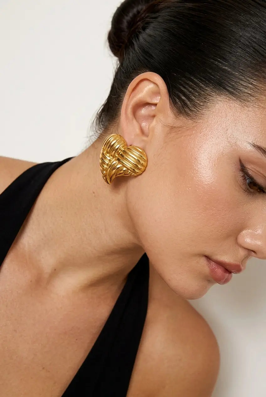 Woven heart stud earrings worn on ear — YUBAMA waterproof gold heart stud earrings