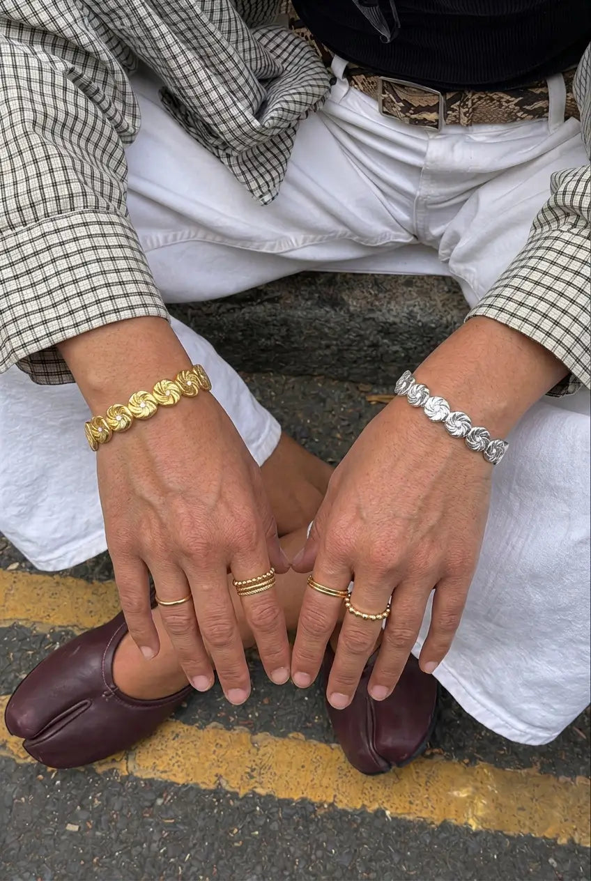Floral link crystal bangle worn on wrist — YUBAMA 18K gold PVD waterproof bangle