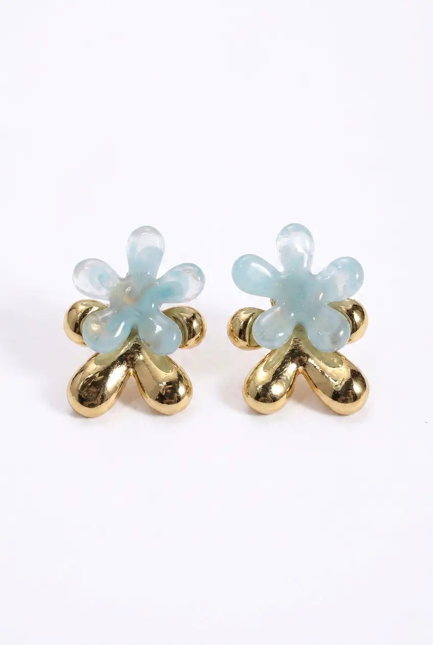 A pair of gold flower-shaped stud earrings with translucent light blue stone petals, shown on a plain white background.