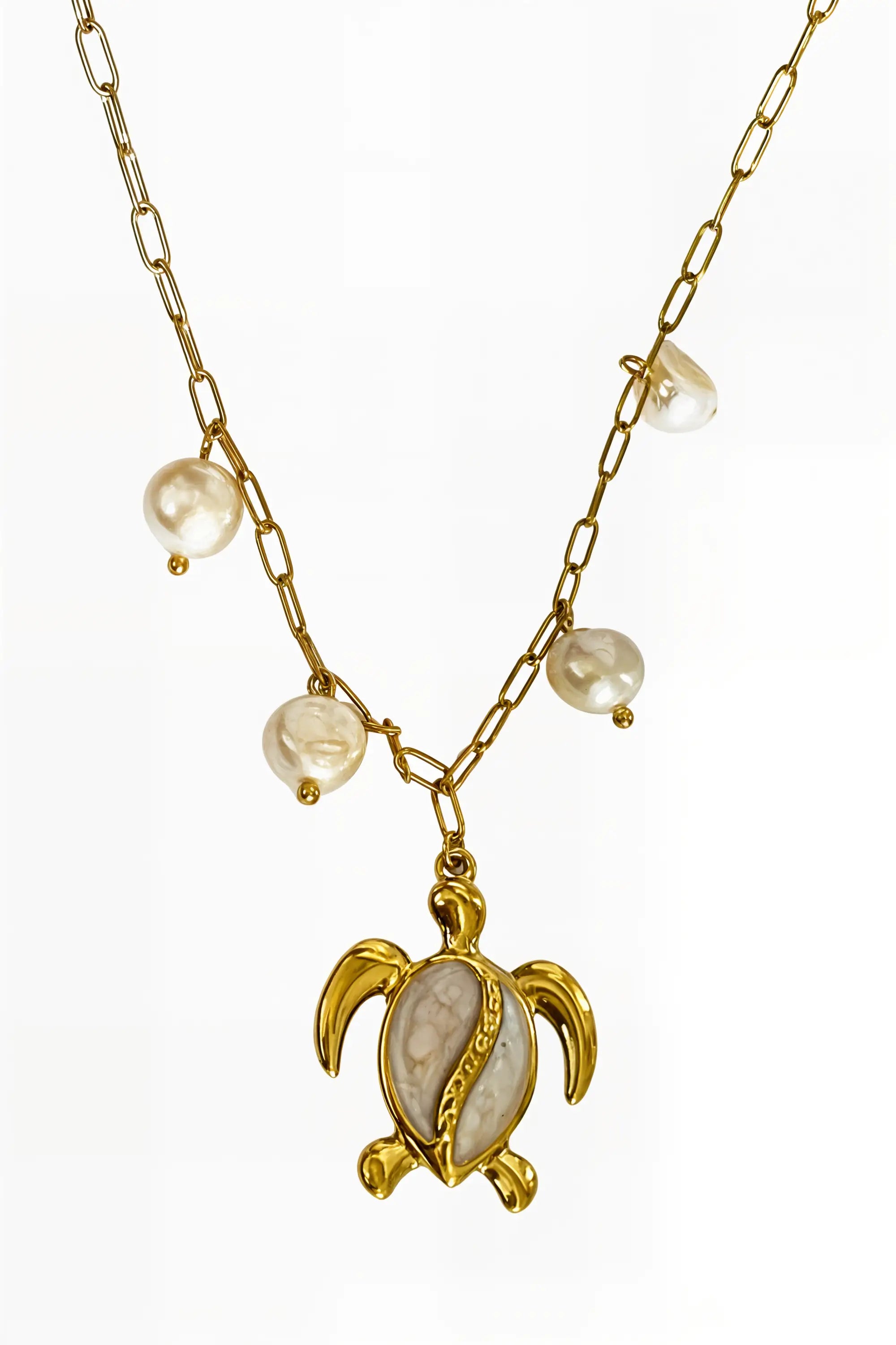 A gold chain necklace featuring five irregular white baroque pearls and a gold turtle pendant with a white inlay, shown against a plain white background.