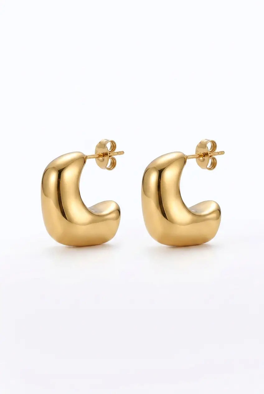 A pair of gold crescent-shaped hoop earrings with a polished finish and butterfly backings, displayed on a clean white background.