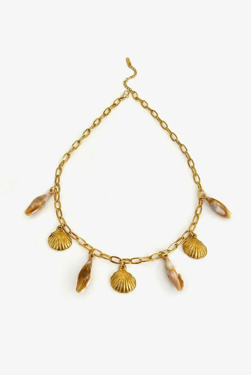 A gold-tone chain necklace featuring shell-shaped charms and translucent amber-colored teardrop beads, displayed against a clean white background.