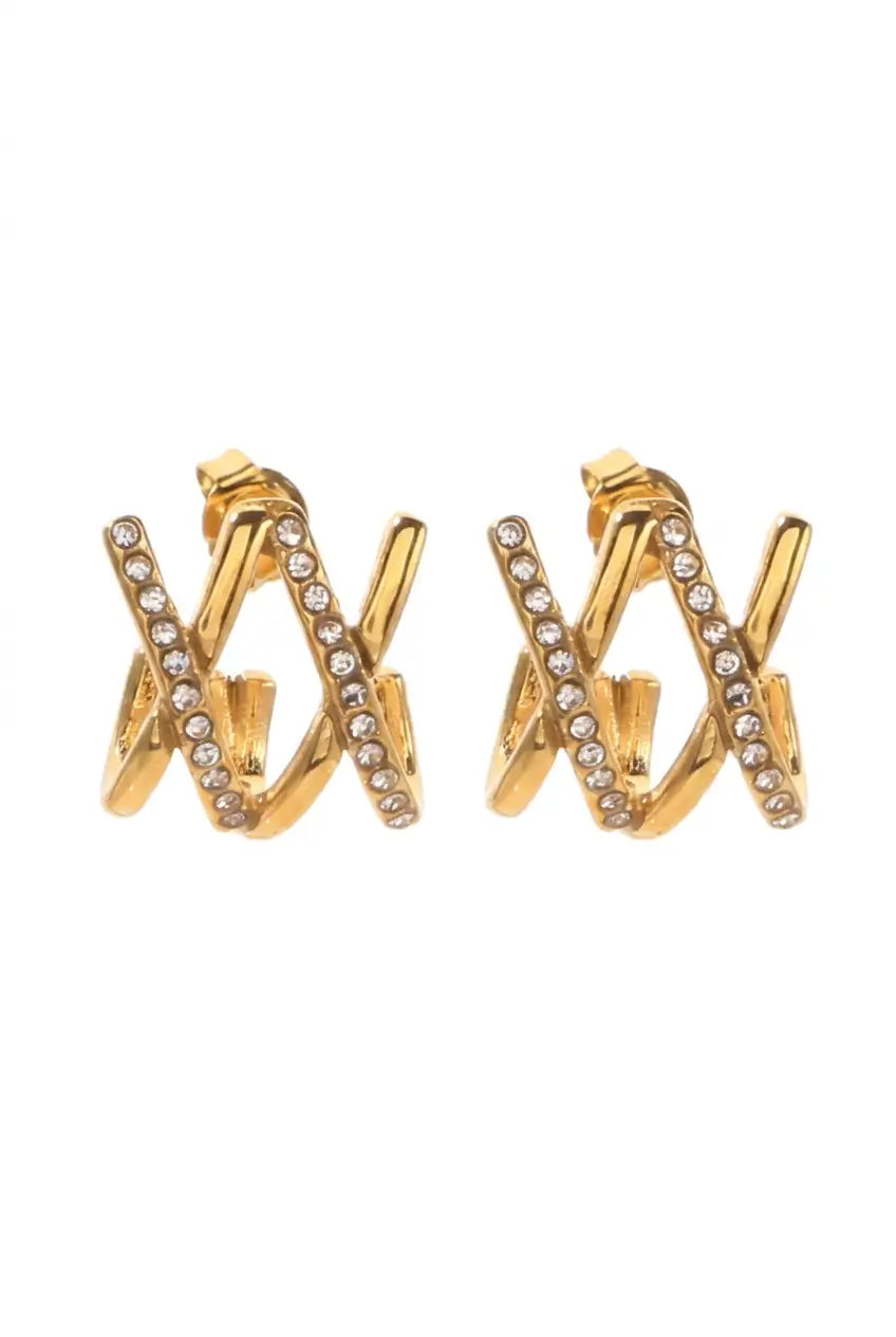 A pair of gold-toned huggie hoop earrings with rows of clear rhinestones, shown on a plain white background.