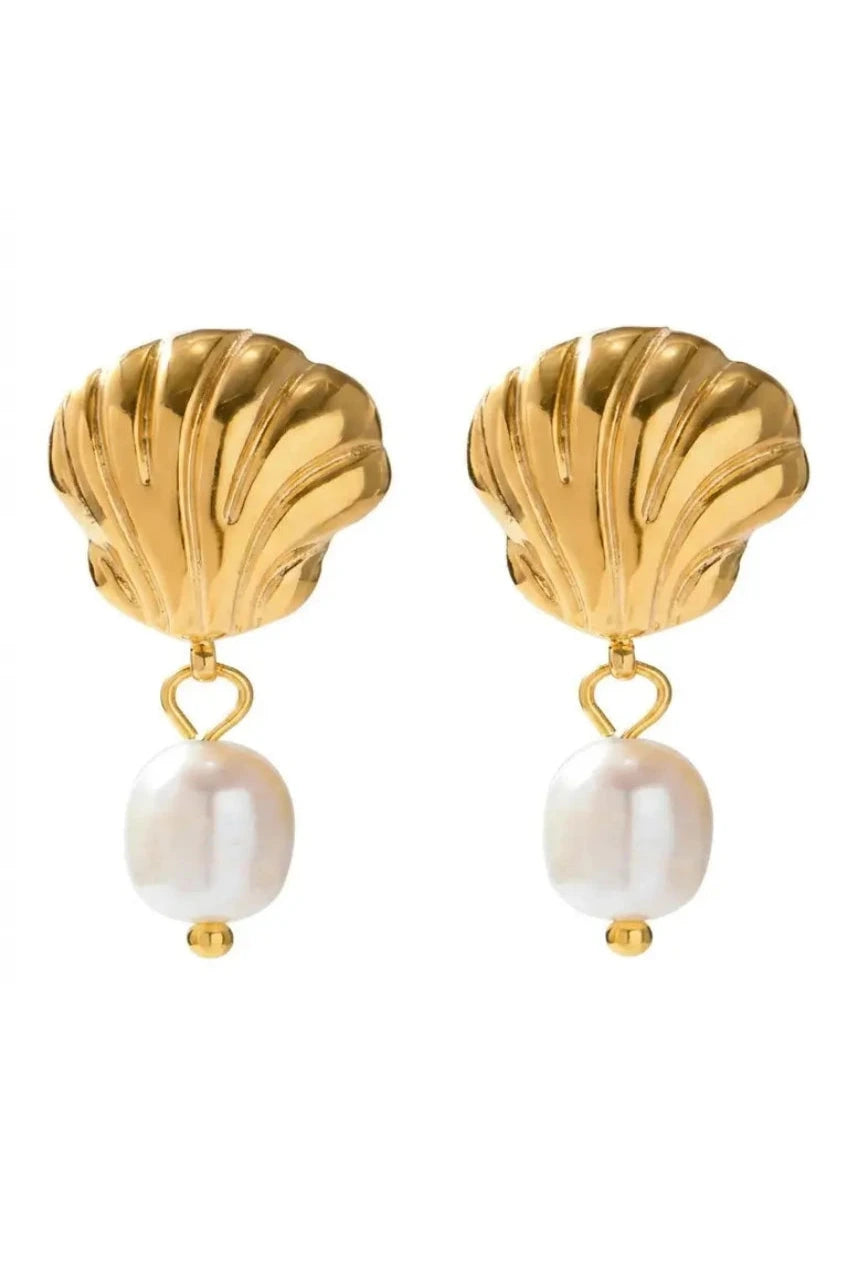 A pair of gold shell-shaped drop earrings with white baroque pearl dangles, shown against a plain white background.