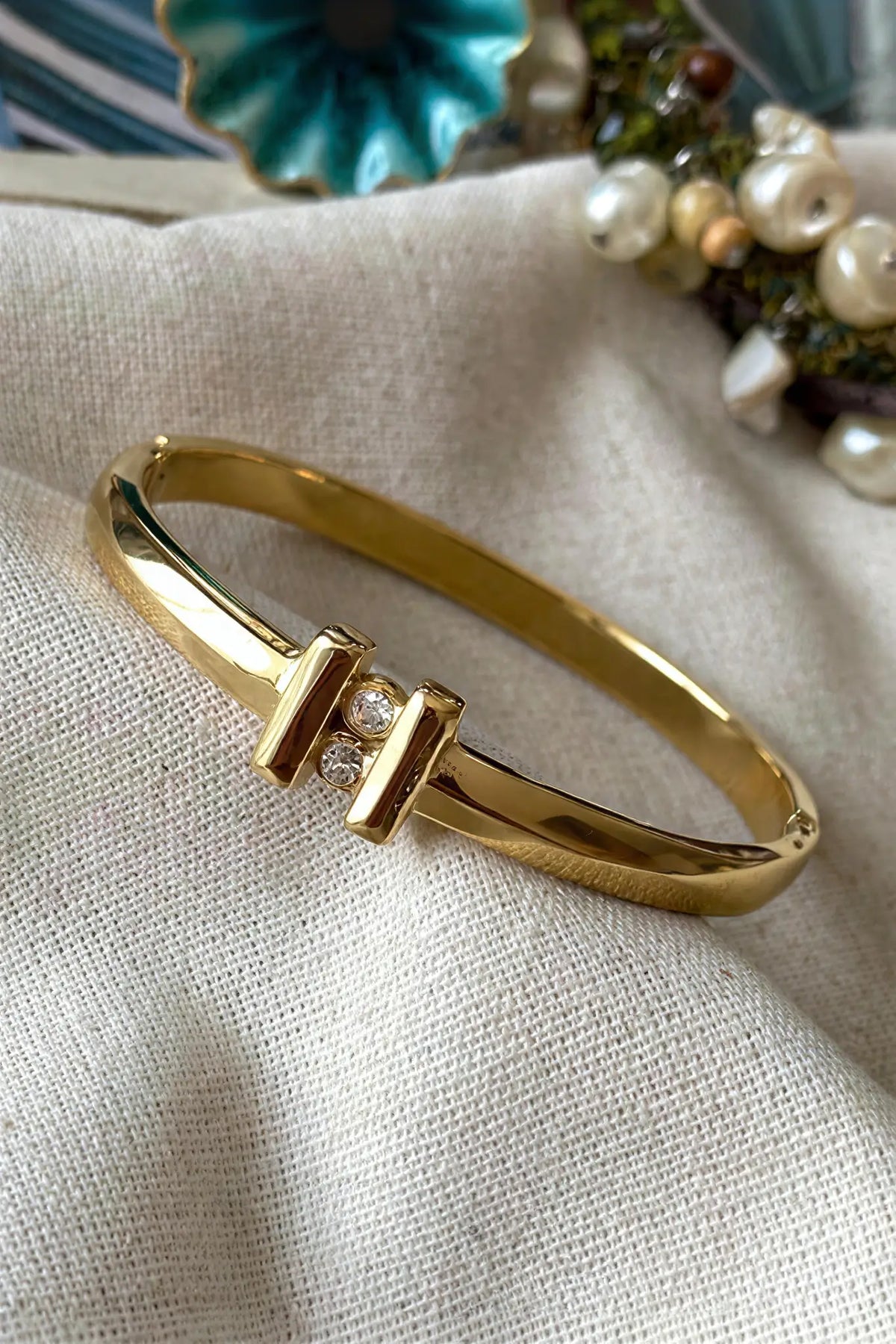 Double bar crystal bangle flat lay — YUBAMA 18K gold PVD hinged bangle