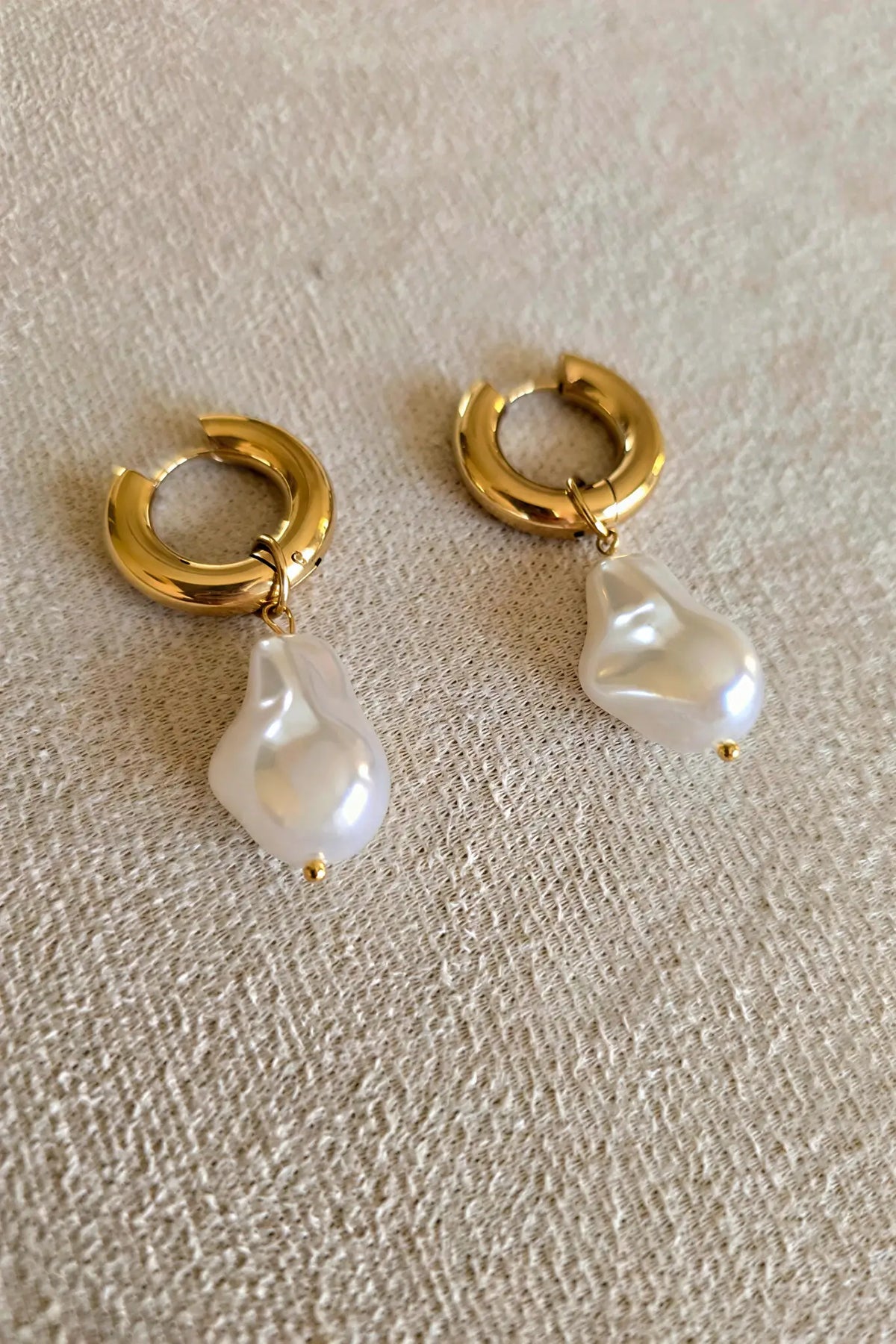 Baroque pearl drop hoop earrings flat lay — YUBAMA 18K gold PVD pearl earrings
