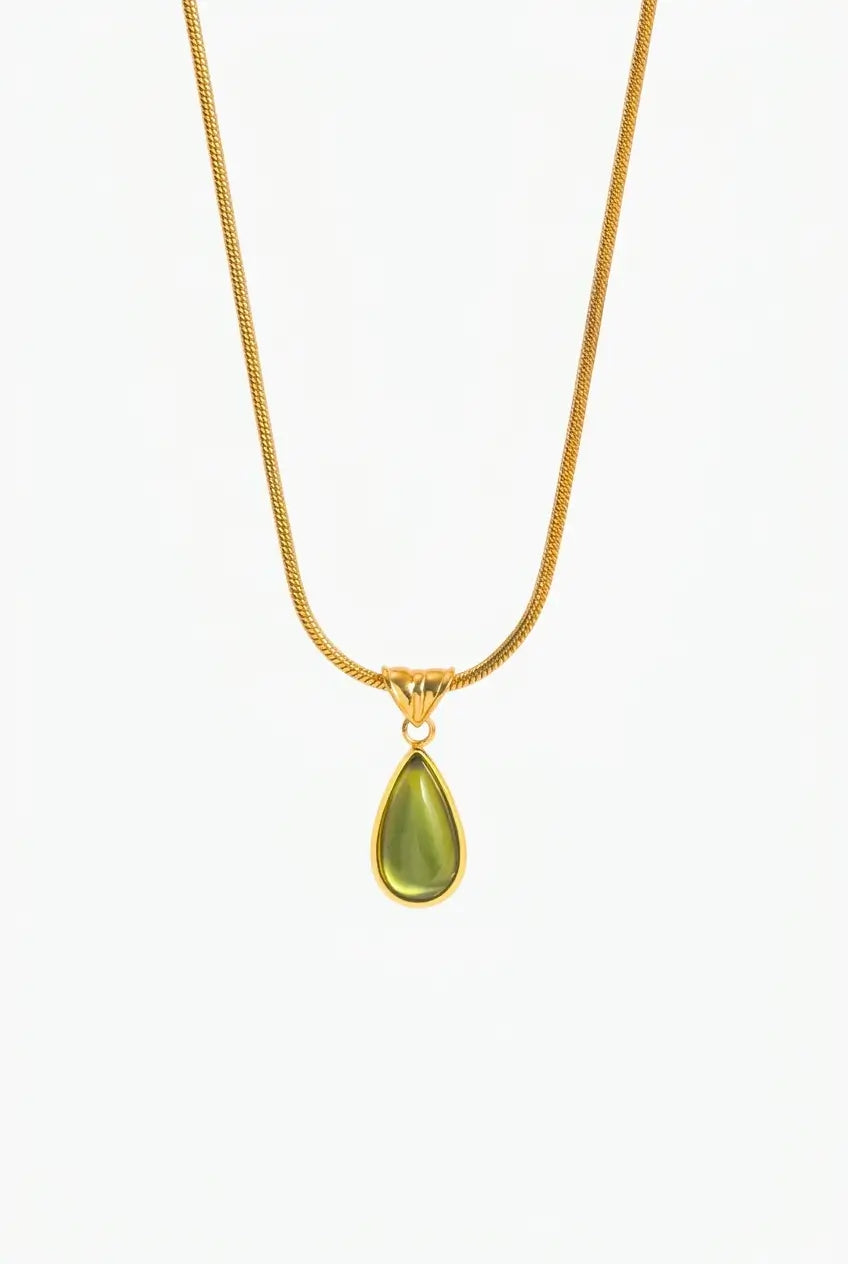 A gold chain necklace with a teardrop-shaped olive green pendant, shown against a plain white background.