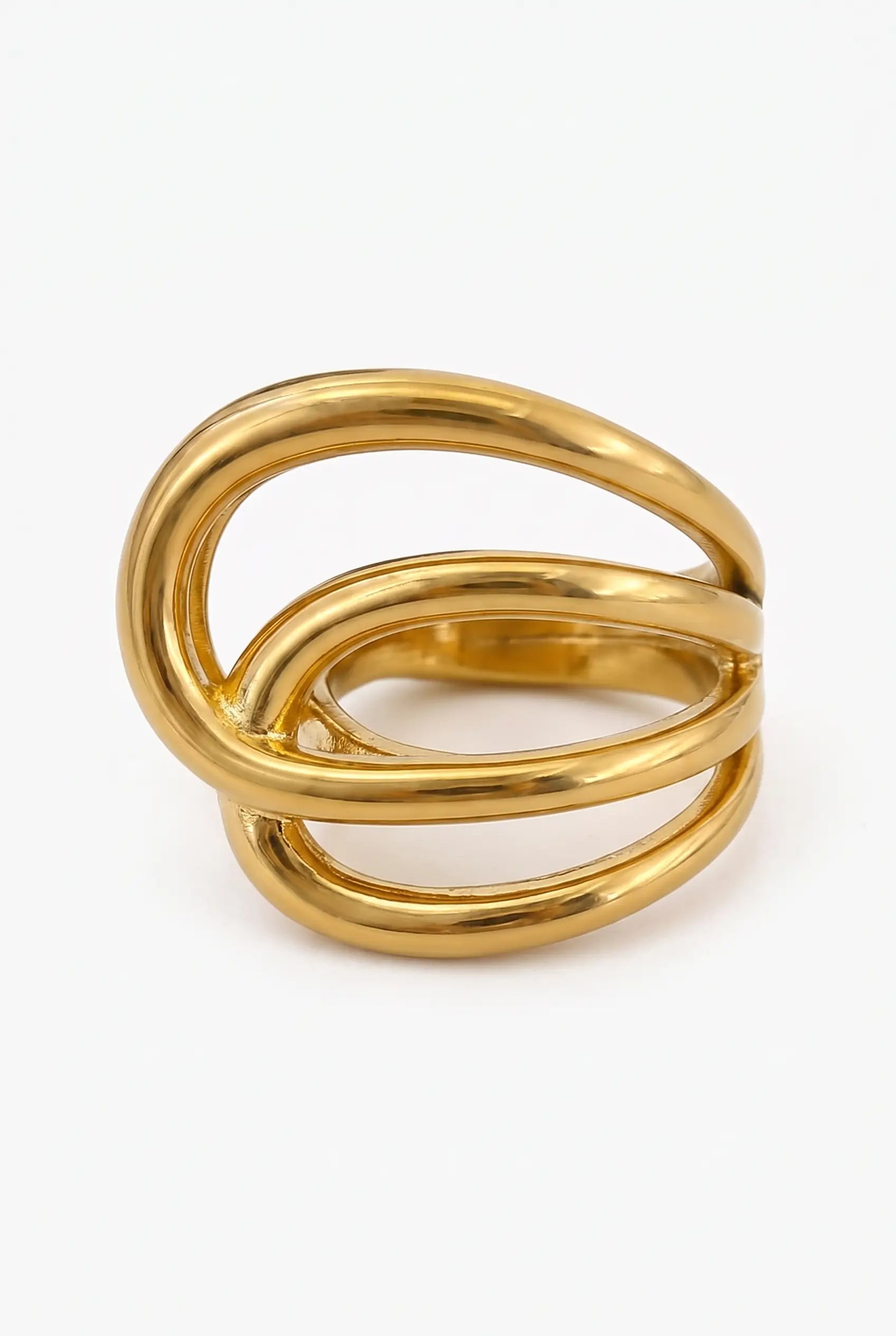 A gold-toned metal ring with a thick, sculptural double-loop design, photographed on a clean white background.