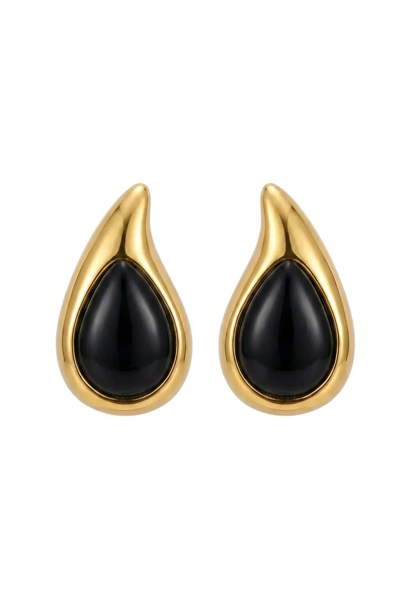 A pair of gold teardrop-shaped earrings with smooth black inlay, shown against a plain white background.