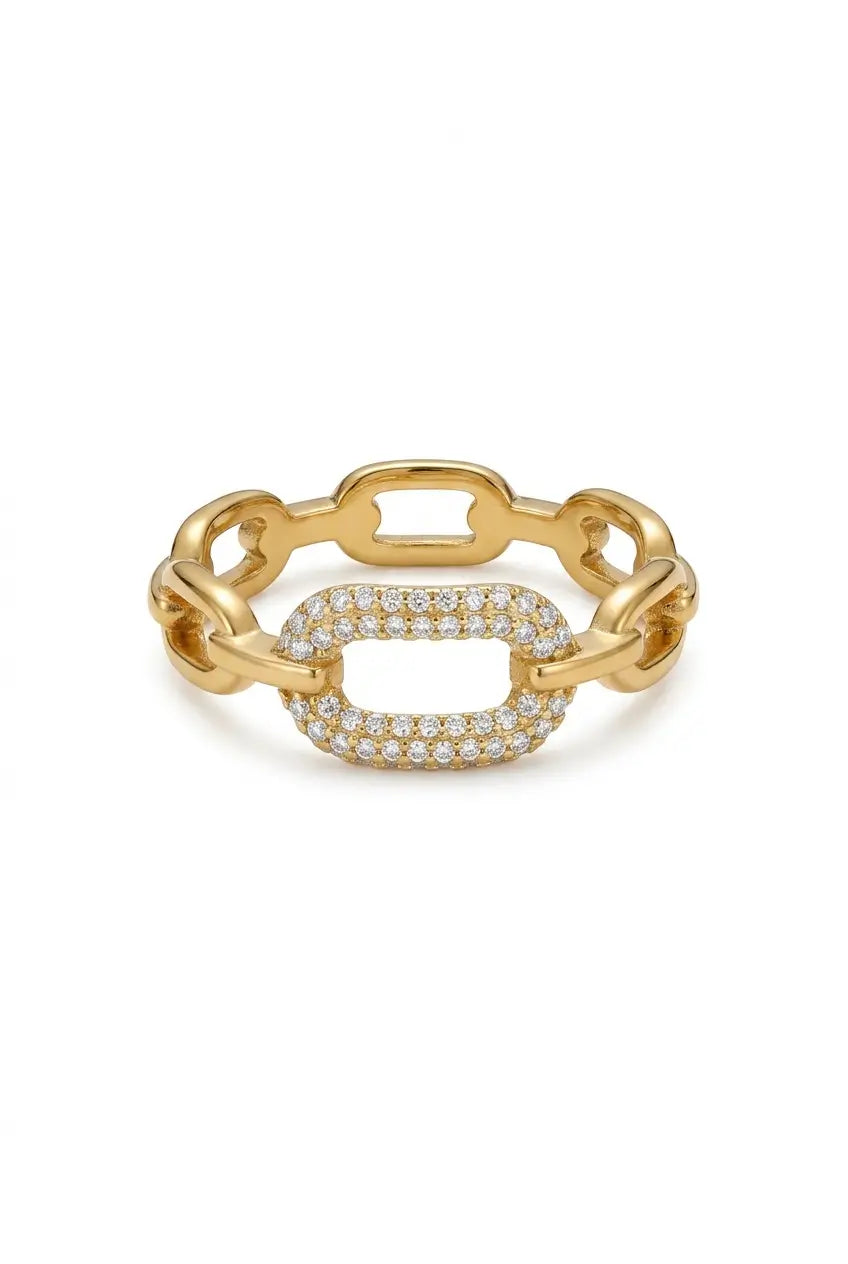 A gold link chain ring featuring a central pavé-set oval cluster of clear stones, photographed on a clean white background.