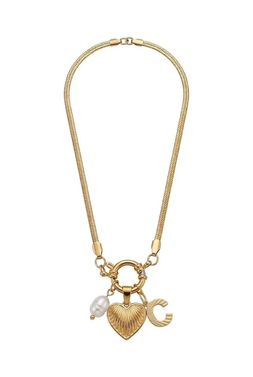 A gold-tone snake chain necklace featuring a toggle clasp and three dangling charms: a textured gold heart, a gold letter C, and a small white pearl bead.