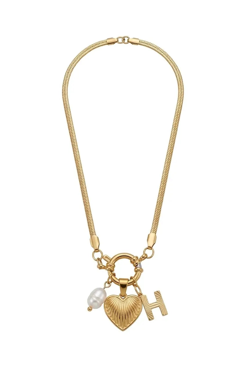 A gold-toned snake chain necklace featuring a textured heart-shaped pendant, a small white pearl bead, and a custom capital letter 'H' charm, displayed on a clean white background.