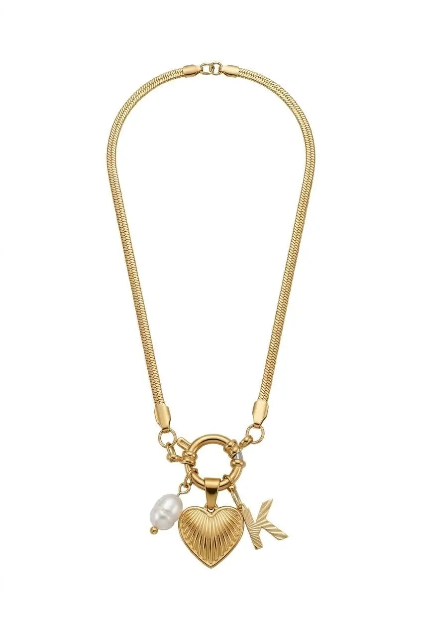 A gold-toned snake chain necklace featuring a heart-shaped charm with a textured ribbed finish, a small white pearl bead, and a delicate leaf charm, displayed on a solid white background.