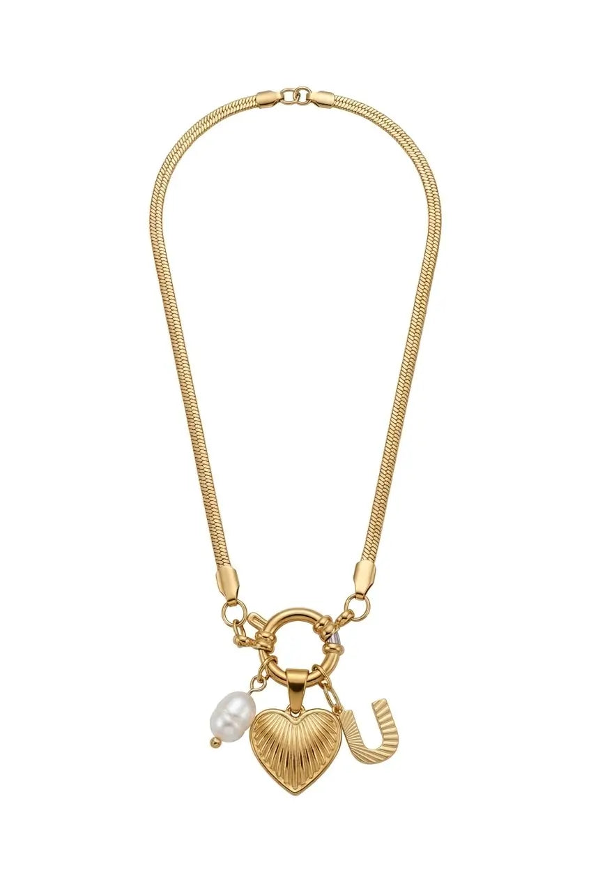 A gold-tone chain necklace featuring a heart-shaped charm with a ribbed texture, a small white pearl bead, and a gold horseshoe charm, displayed on a clean white background.