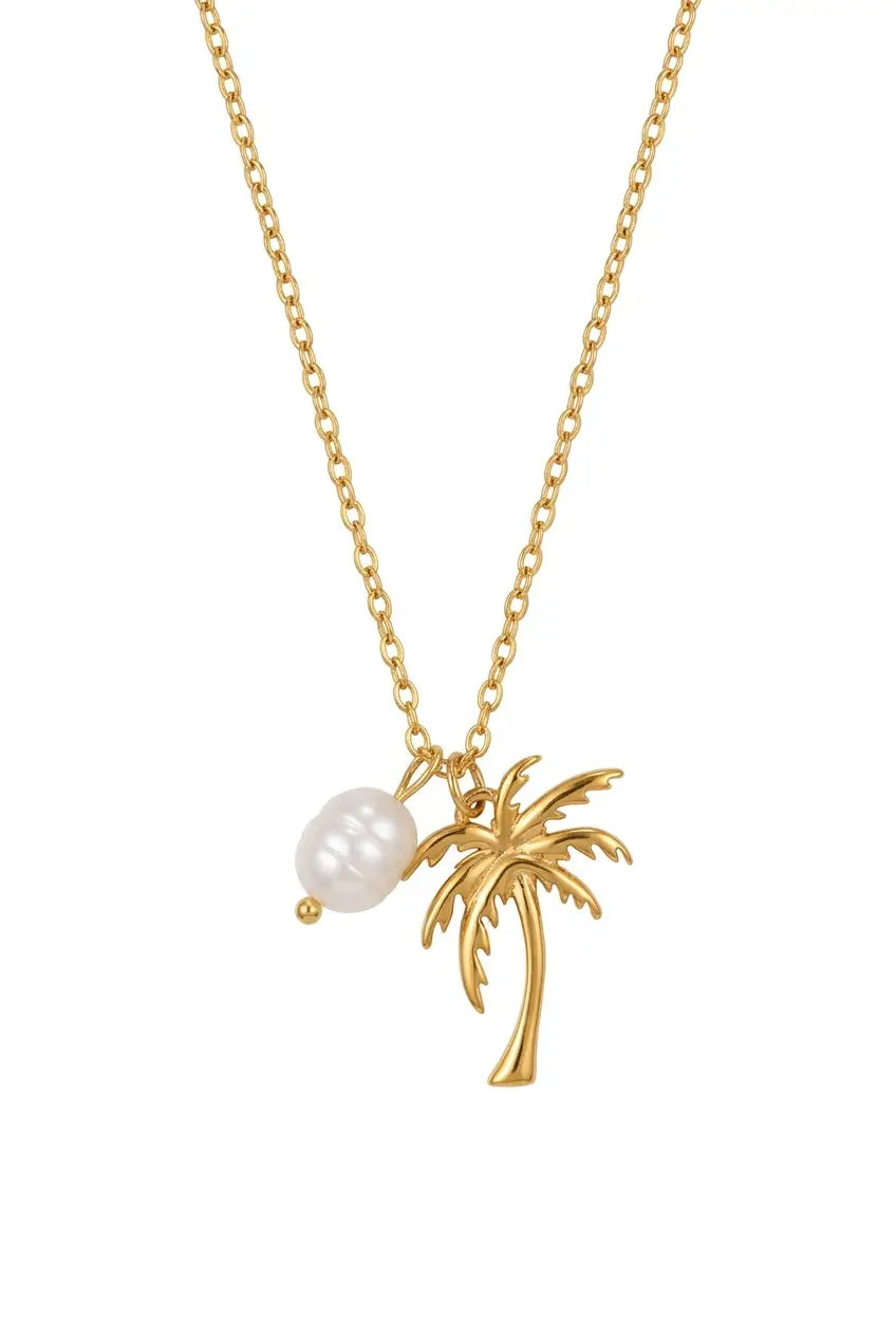 A gold chain necklace featuring a small palm tree pendant and a dangling white pearl bead, shown against a plain white background.