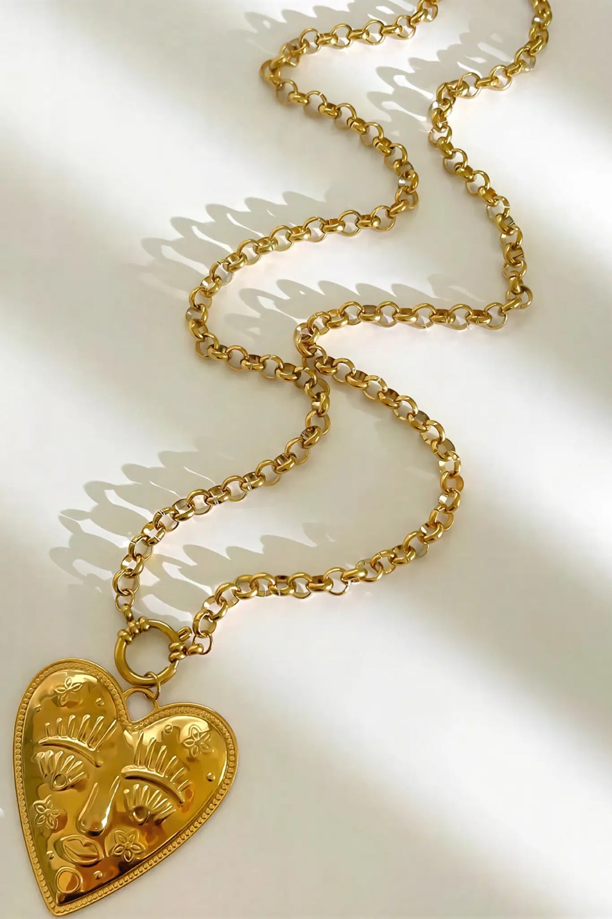 Engraved face heart pendant necklace detail — YUBAMA gold heart pendant necklace