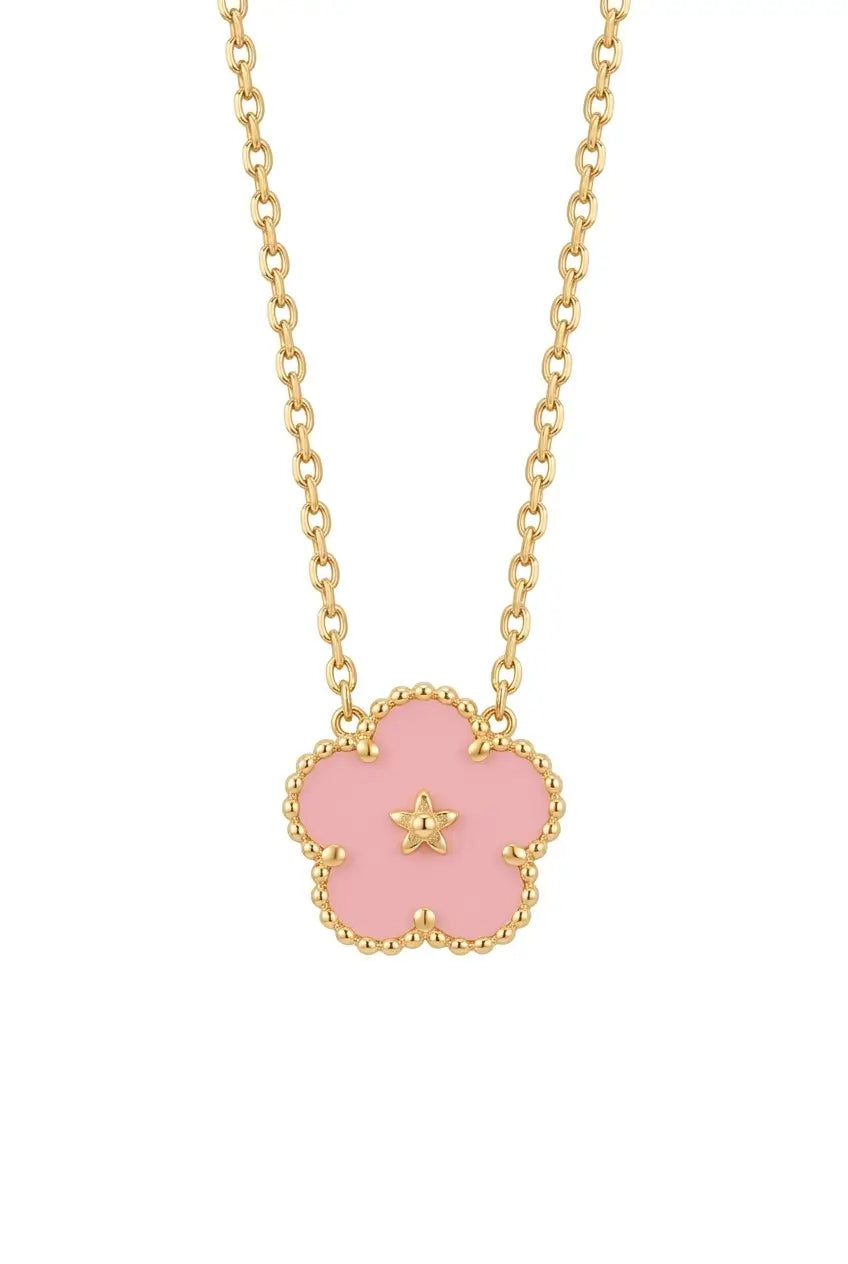 A gold chain necklace featuring a five-petal flower pendant with a light pink enamel center and a small gold star in the middle, set against a plain white background.
