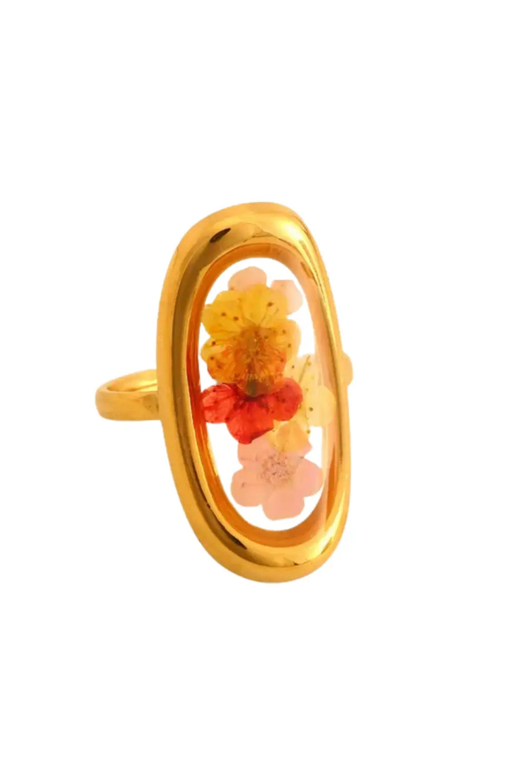 A gold ring featuring an oval bezel with dried flowers in shades of yellow, orange, red, and pink, set against a plain white background.