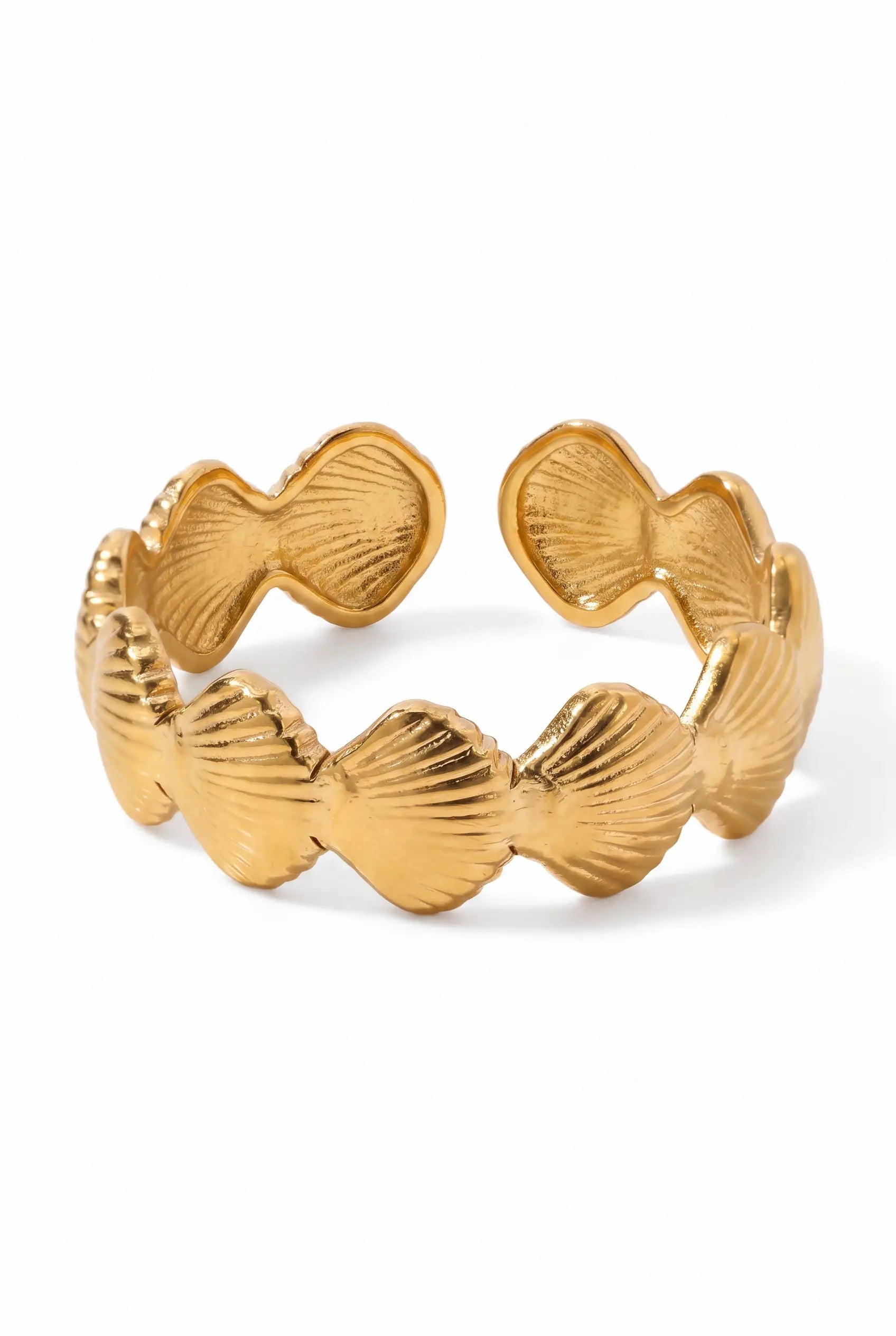 A gold-toned open cuff bracelet featuring a row of textured, scalloped shell-like links, shown on a clean white background.