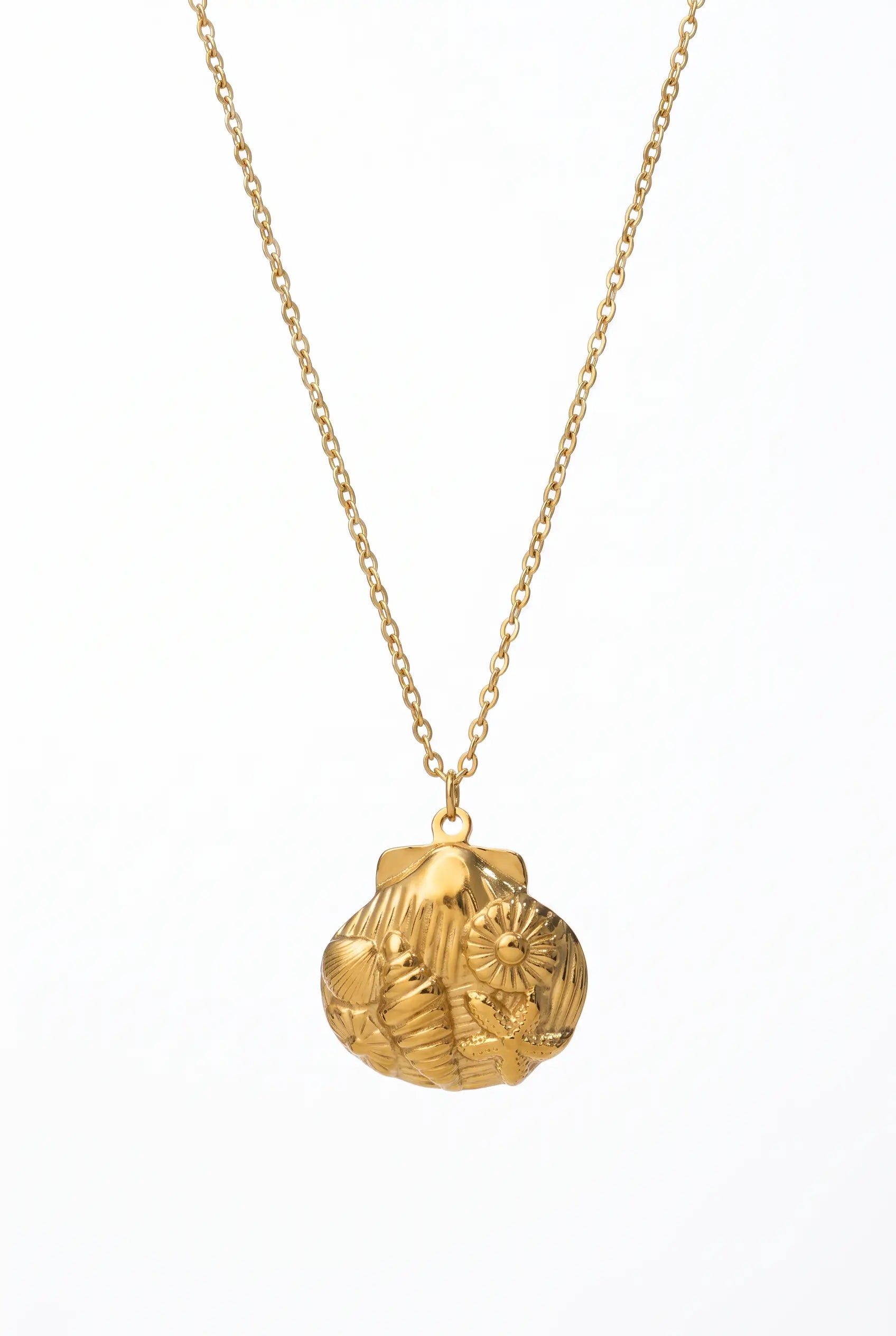 A gold pendant necklace featuring a textured, organic-shaped pendant with engraved floral or leaf-like patterns, suspended from a delicate gold chain against a plain white background.