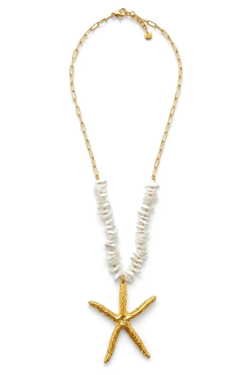 A gold-toned chain necklace featuring a textured gold starfish pendant and a central strand of white shell-like beads, shown against a plain white background.