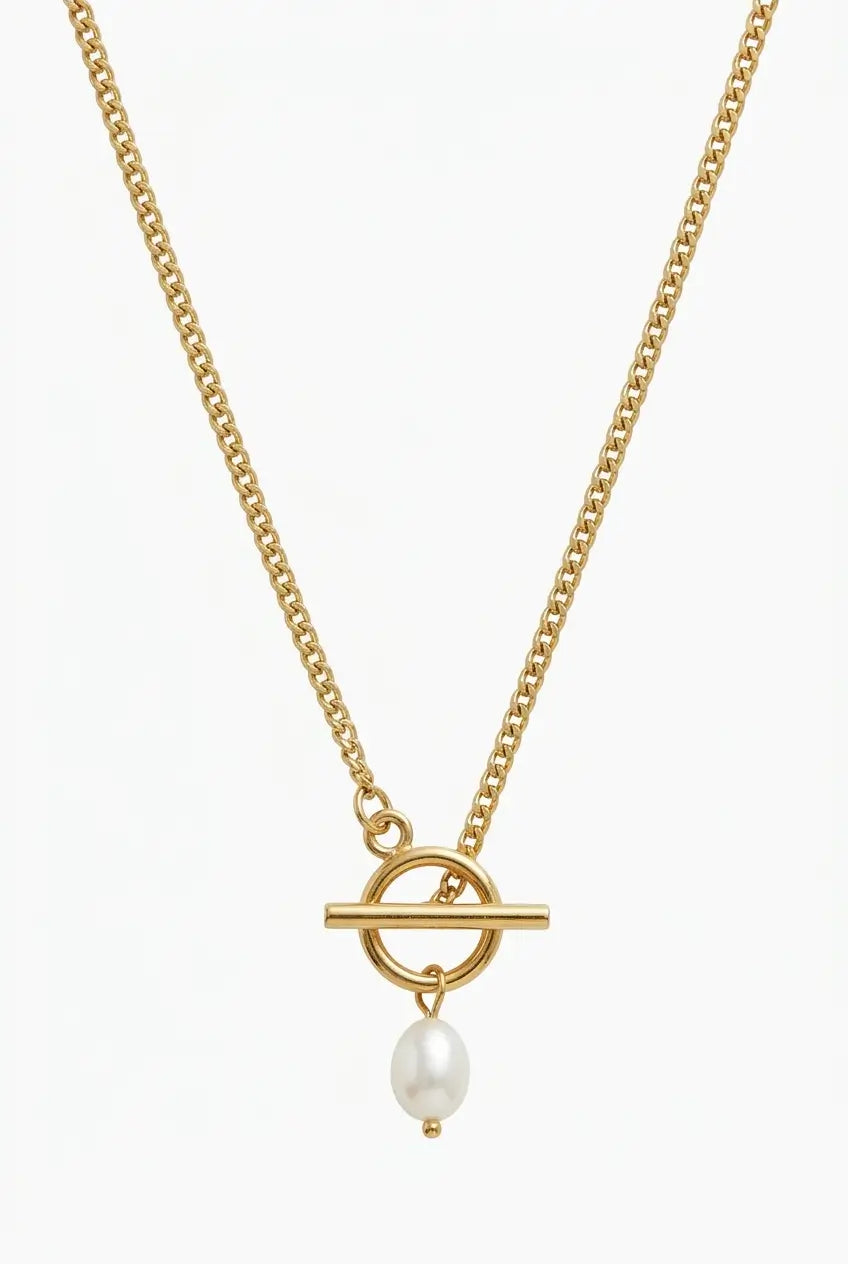 A gold chain necklace featuring a toggle bar pendant with a small white pearl hanging below, set against a plain white background.