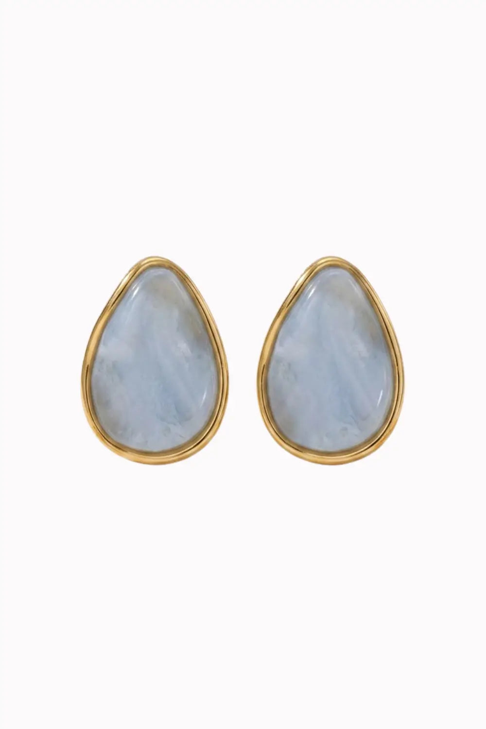 A pair of gold teardrop stud earrings with smooth, light blue-gray stone inlays, shown against a plain white background.
