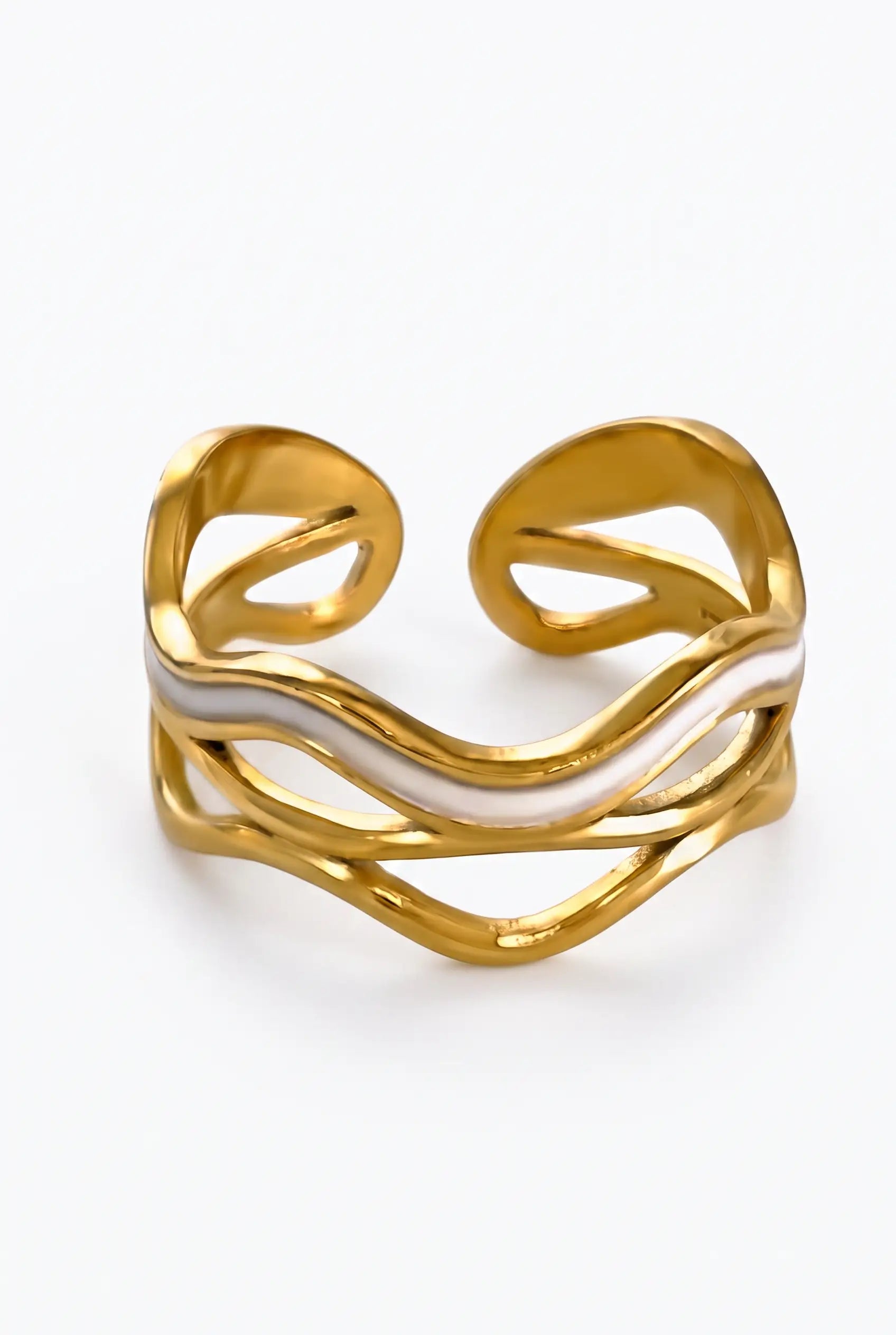 A gold-plated open cuff ring with a wavy, flowing design and a central white inlay, shown on a clean white background.