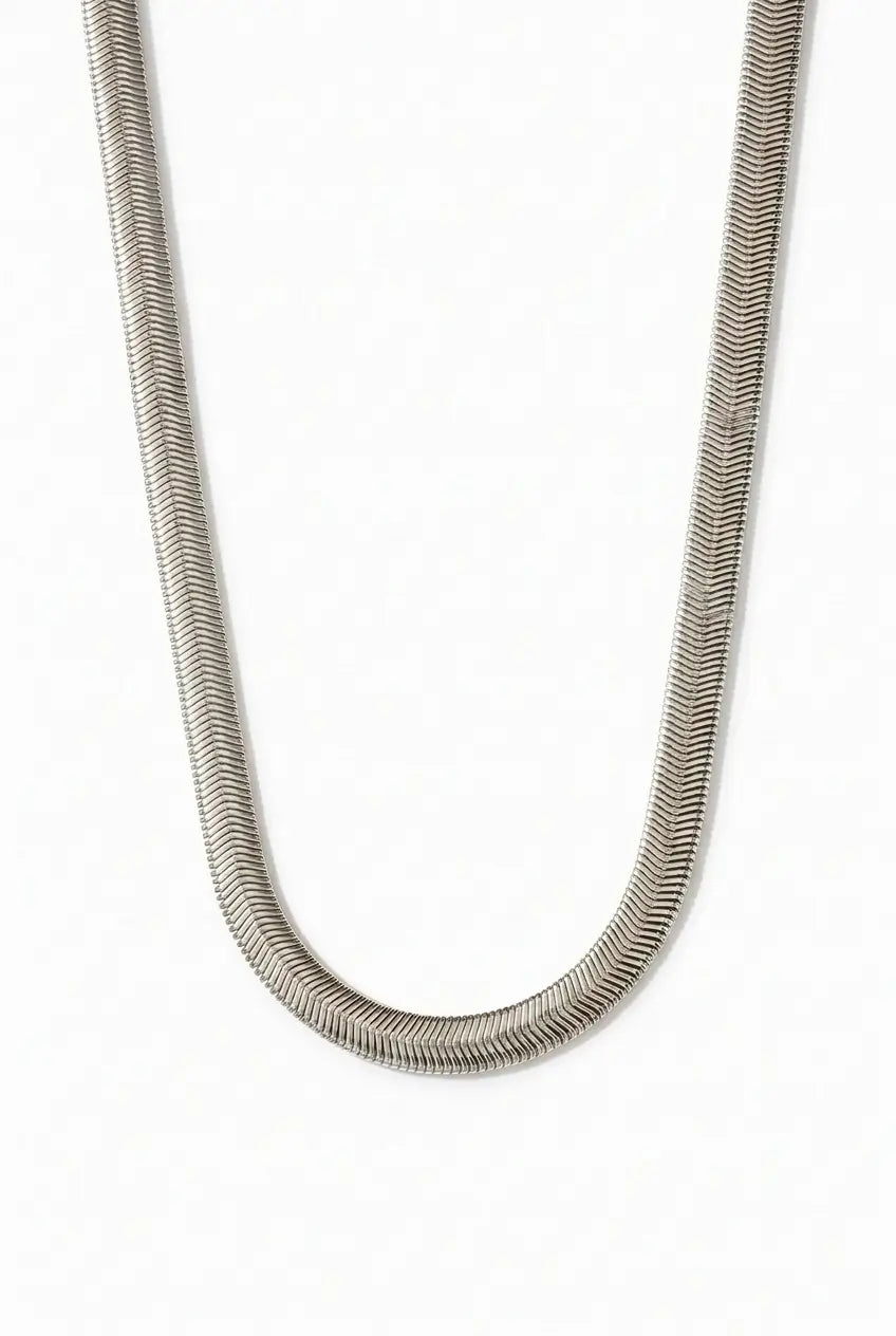 A silver-toned snake chain necklace with a textured, scale-like pattern, shown draped in a U-shape against a plain white background.
