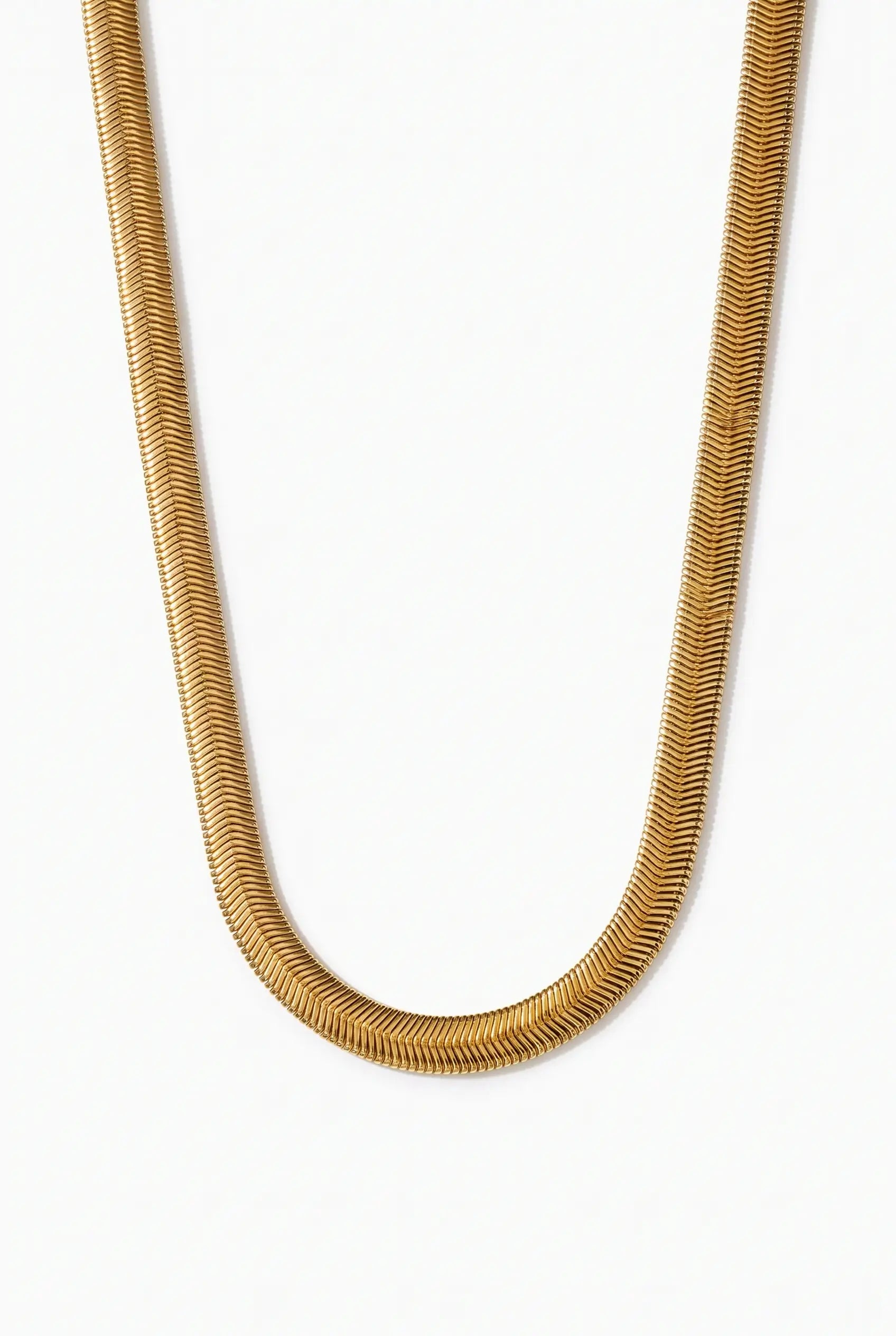 A close-up of a textured gold snake chain necklace forming a U-shape against a plain white background.