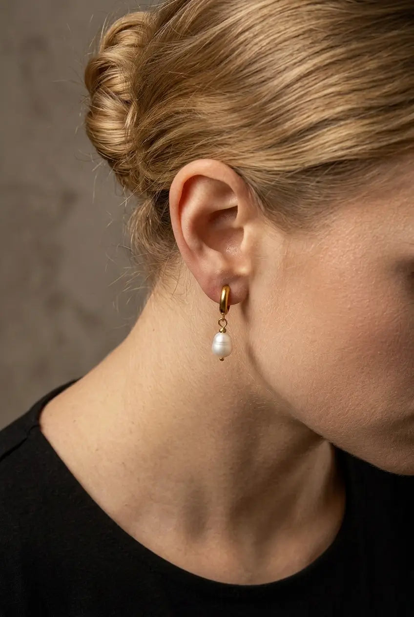 Freshwater pearl huggie drop earrings worn on ear — YUBAMA gold huggie pearl earrings