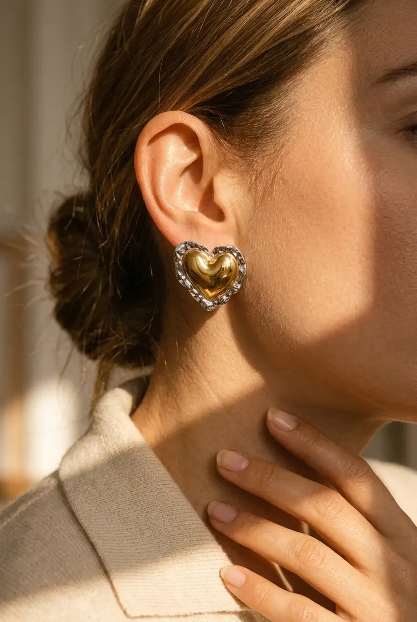 Bold hammered heart stud earrings worn on ear — YUBAMA 18K gold PVD waterproof earrings