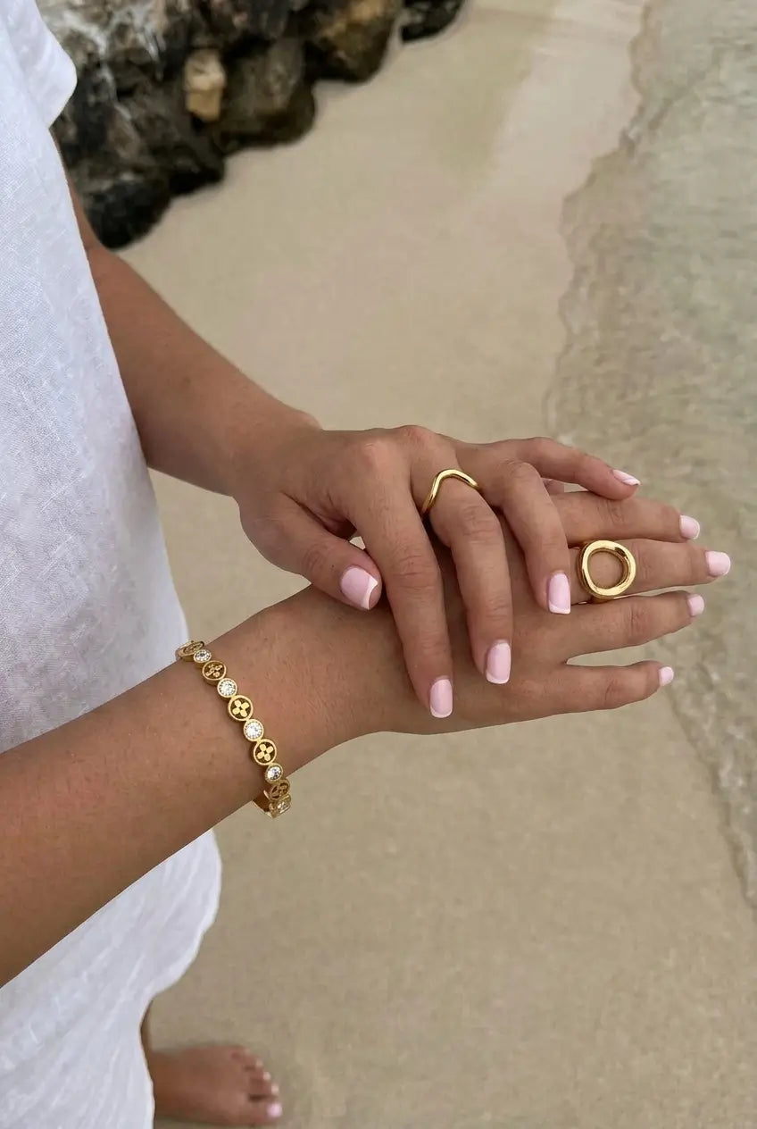 Crystal flower hinged bangle worn at beach — YUBAMA 18K gold PVD waterproof bangle