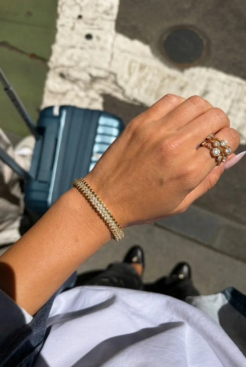 Scalloped crystal bangle worn on wrist — YUBAMA 18K gold PVD waterproof bangle