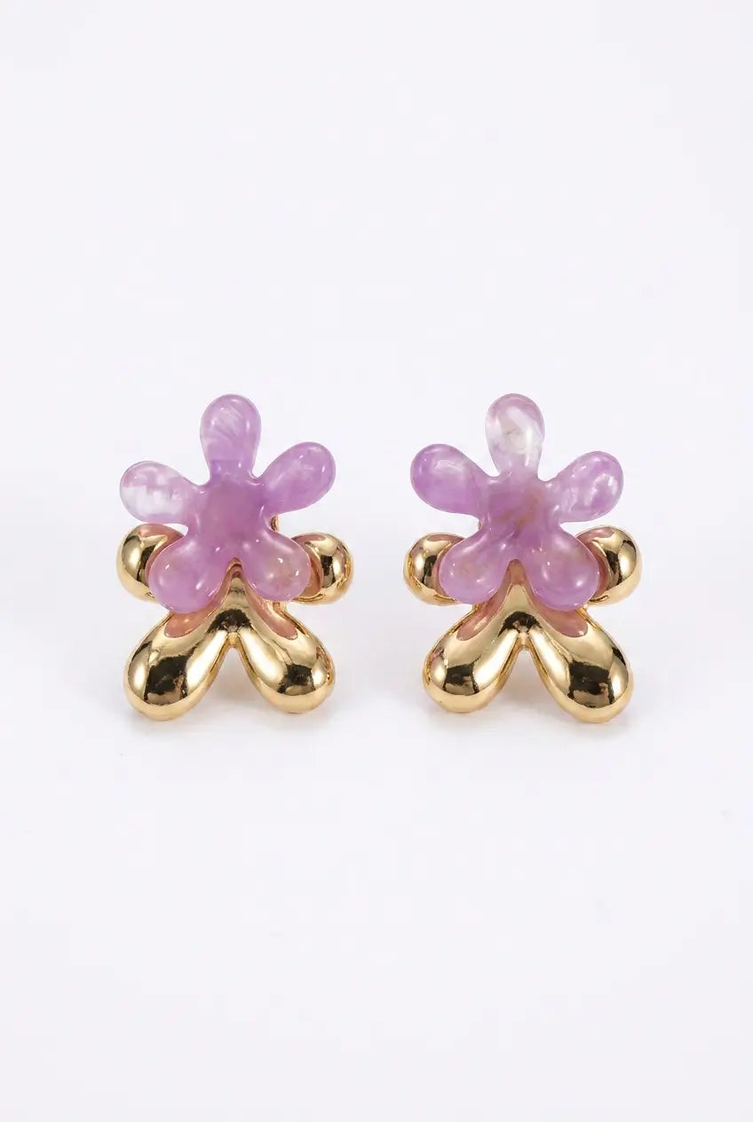 A pair of gold flower-shaped stud earrings with translucent light purple petals, shown on a plain white background.