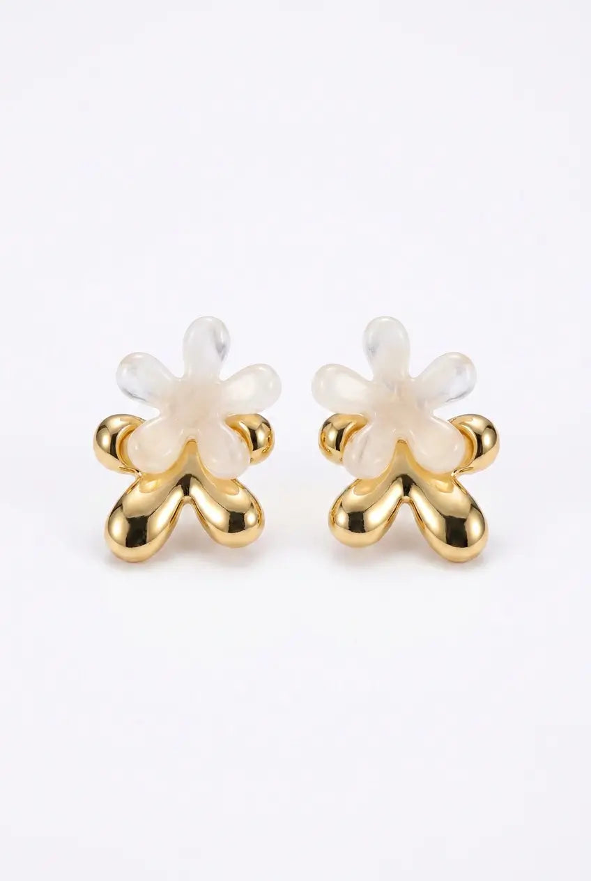A pair of gold and white flower-shaped stud earrings on a clean white background.