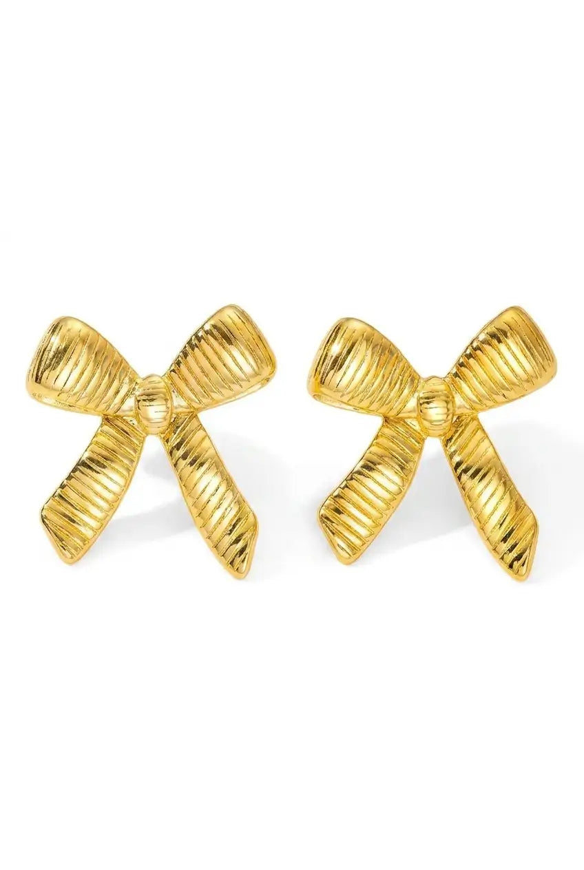 A pair of gold bow-shaped stud earrings with a textured, ribbed surface, displayed on a clean white background.